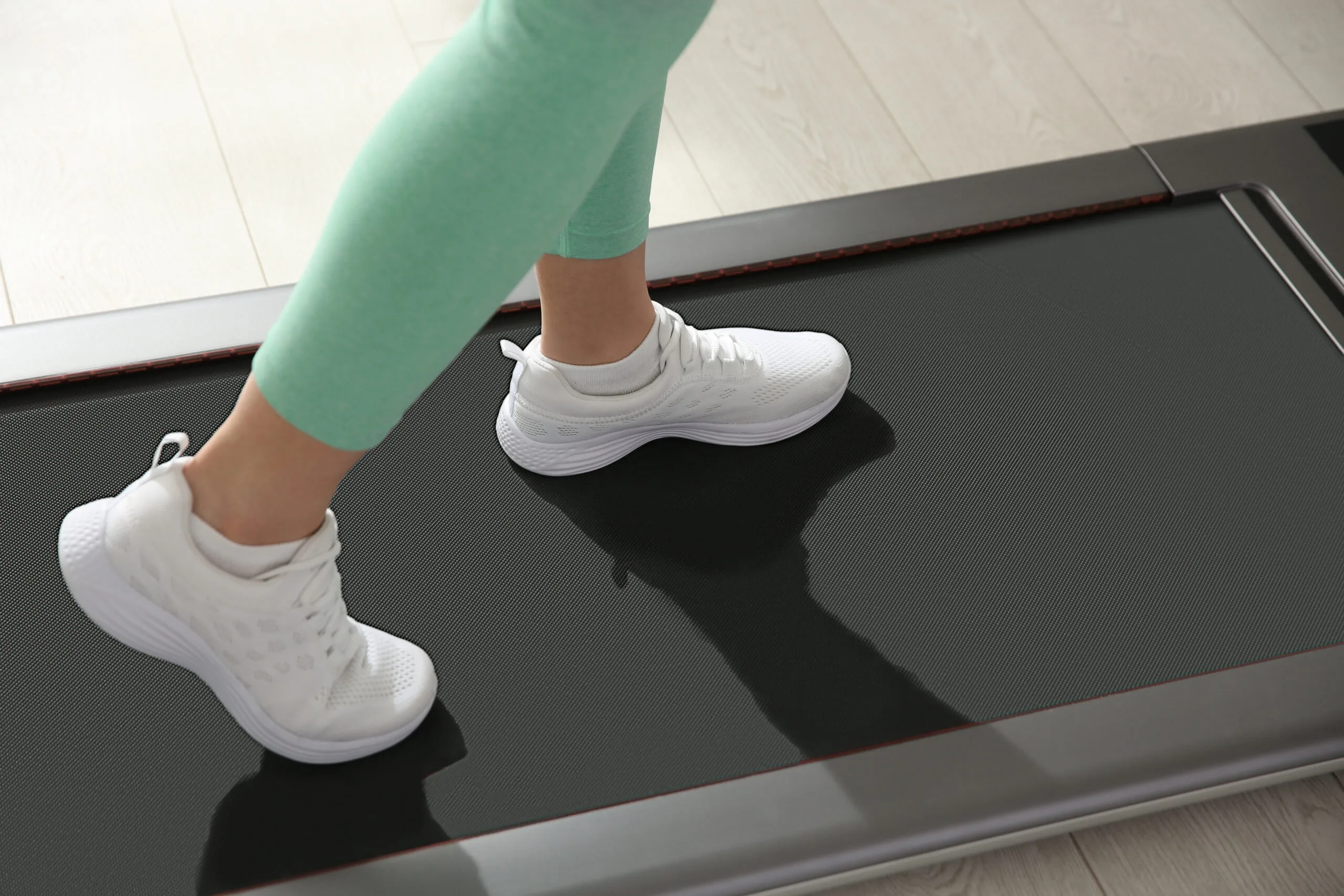 Sporty,Woman,Training,On,Walking,Treadmill,Indoors,,Closeup Clothing, Footwear, Shoe